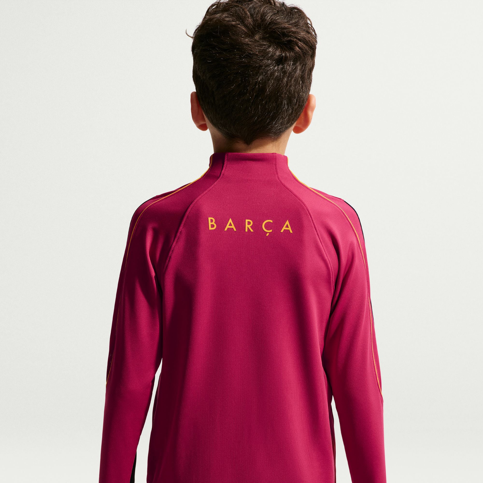 Haut de survêtement Nike Strike Dri-FIT rouge Barcelone 2026/27 pour enfant, manches longues et fermeture éclair au quart.
