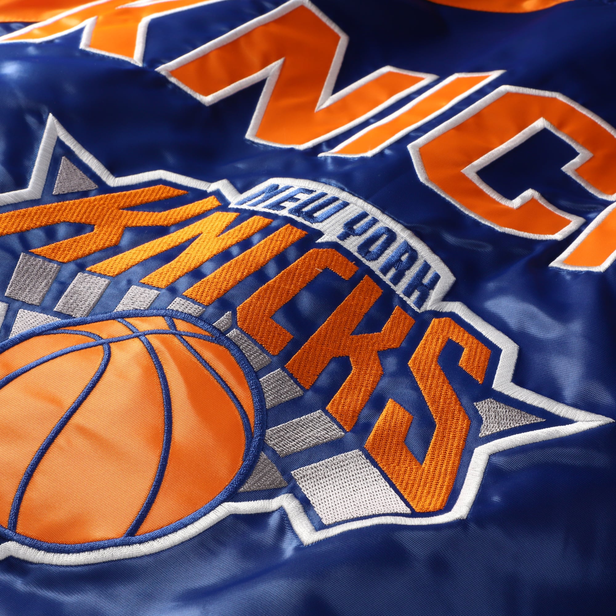 Veste universitaire Starter bleue et orange pour homme, modèle intronisé des New York Knicks, à boutons-pression raglan.