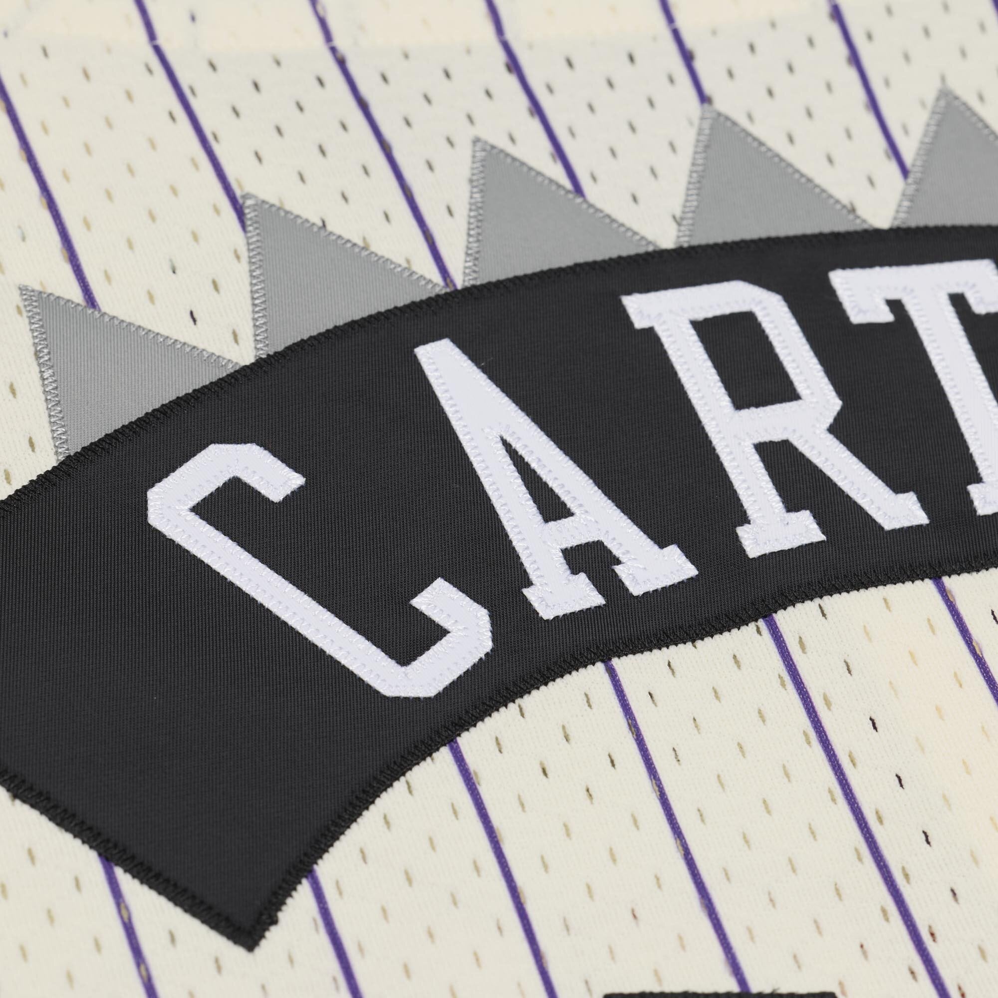 Maillot Mitchell & Ness Vince Carter crème pour homme, modèle Raptors de Toronto, avec boutons sur le devant et maille.